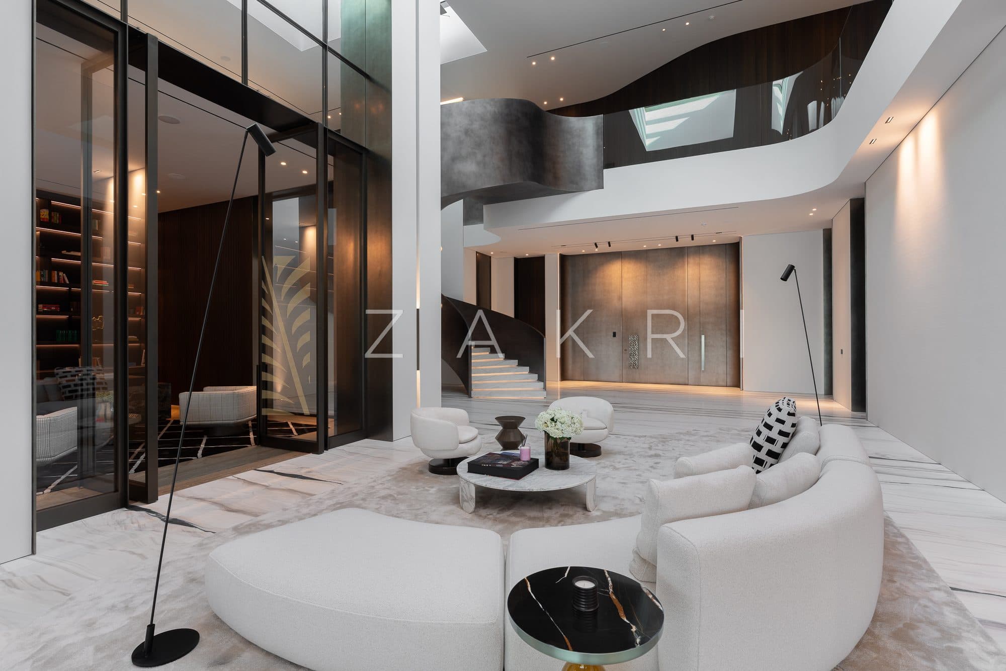 Double-height living space with the wine wall and the stair behind