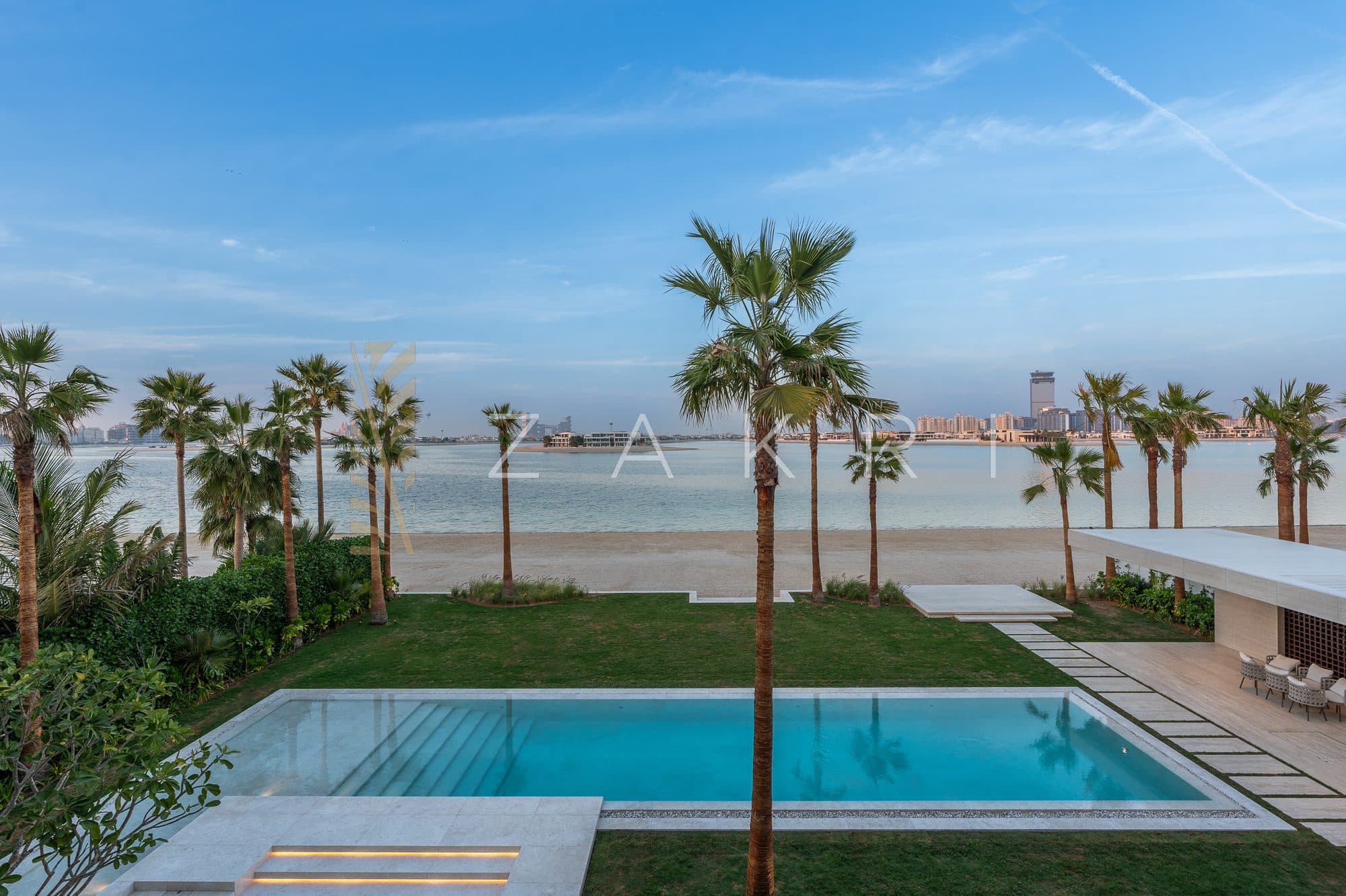 The pool terrace by day, looking out to the beach and the skyline