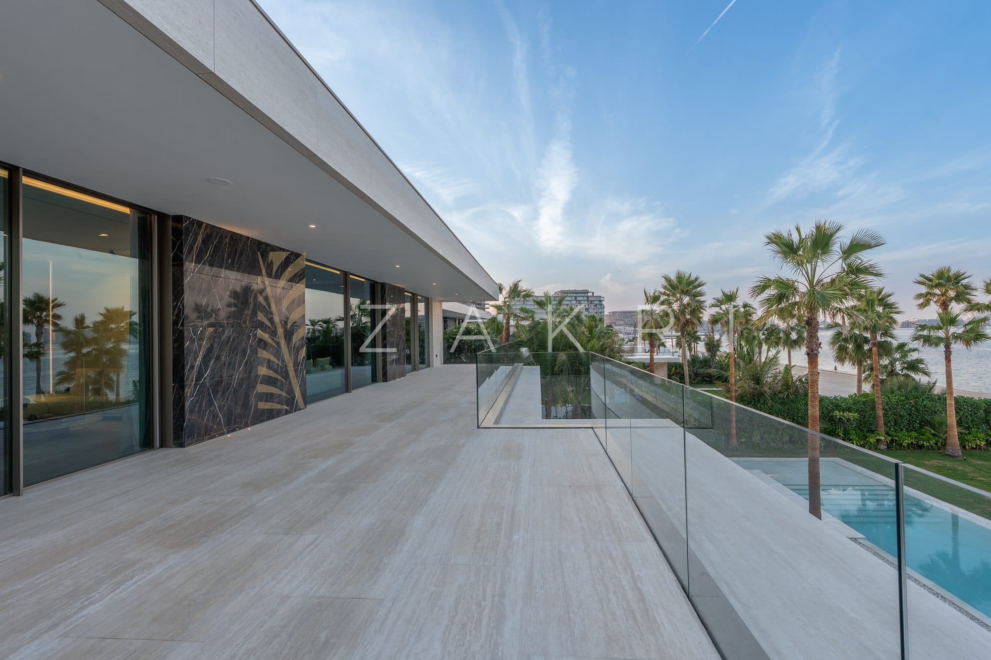 The terrace walkway running alongside the pool