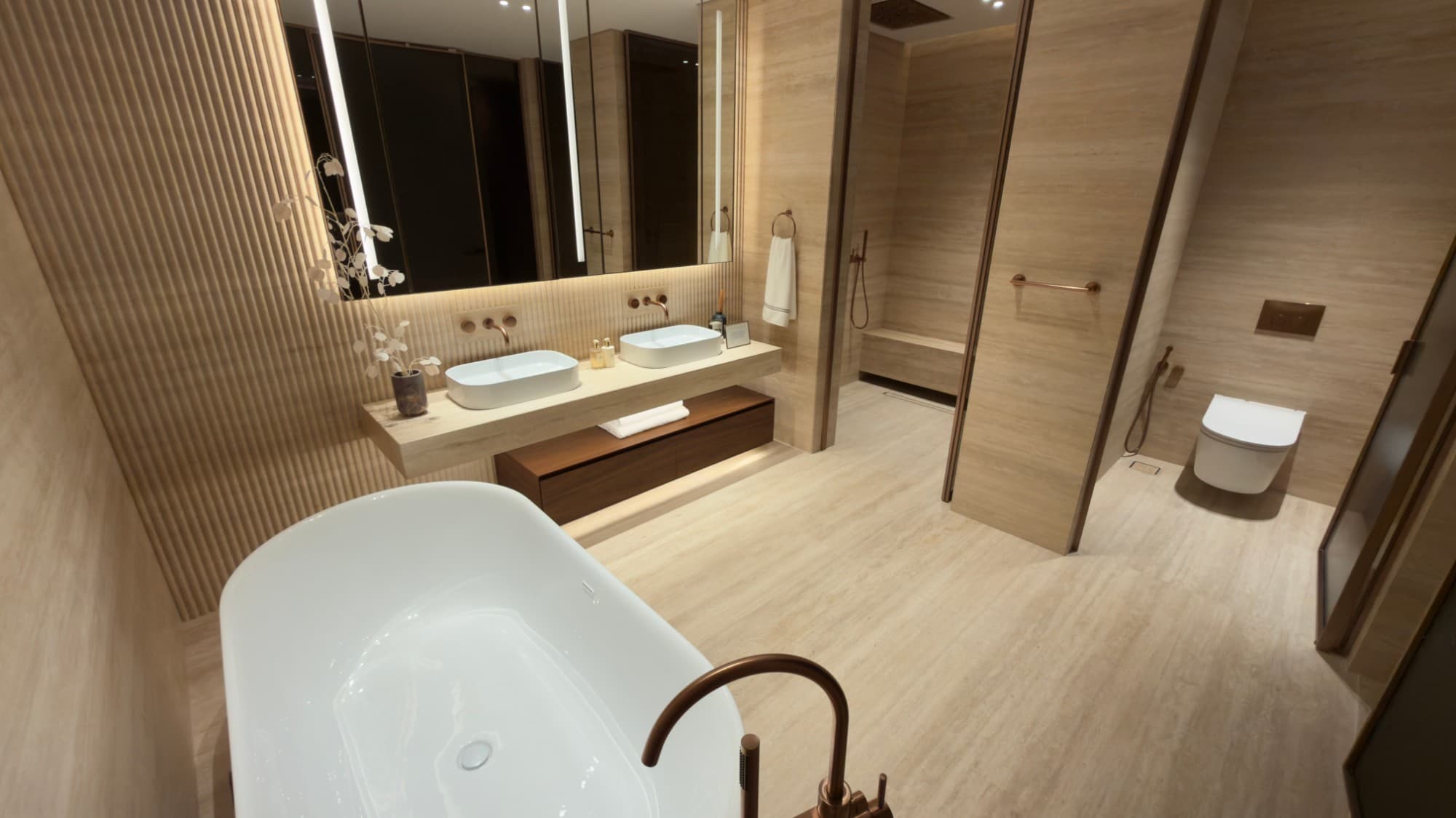 The master bathroom in vein-cut travertine, with a freestanding bath