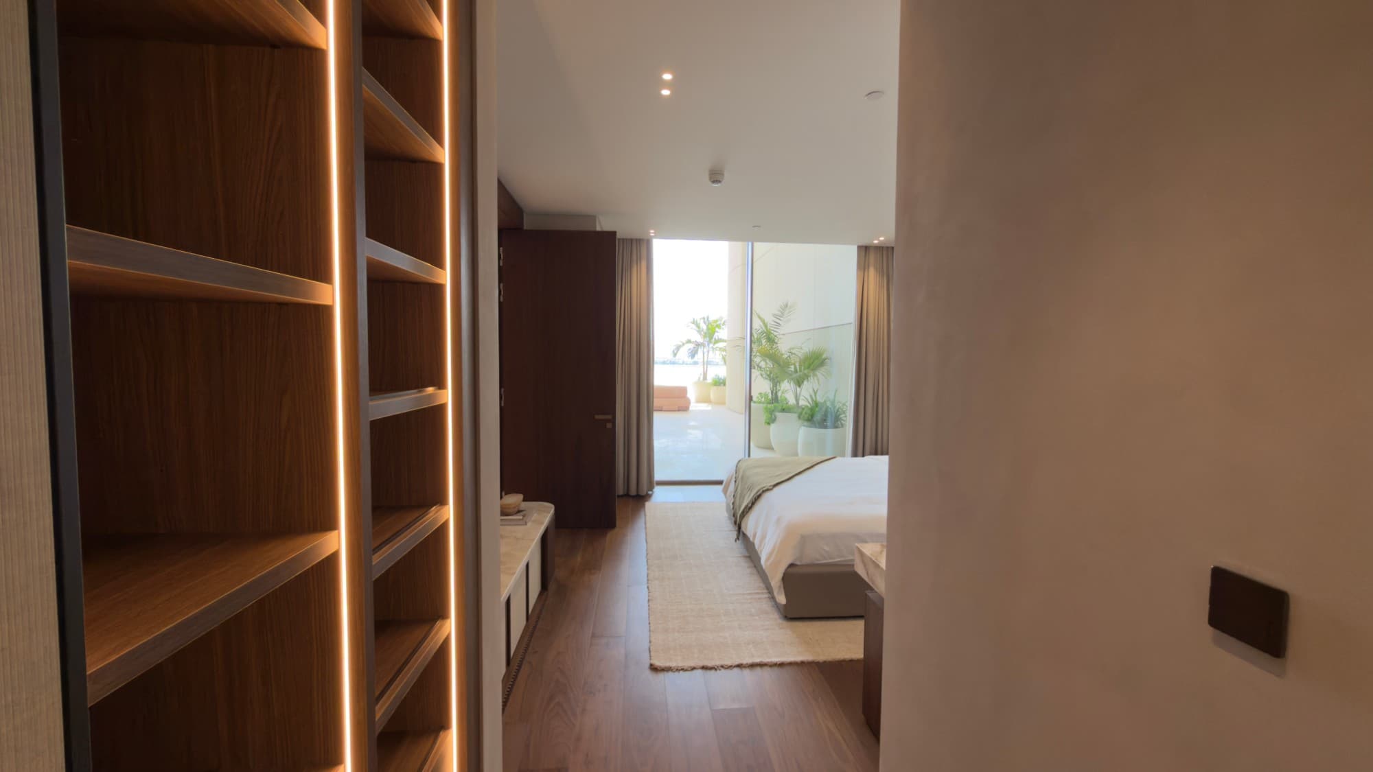 Looking through the dressing room to a bedroom and the terrace