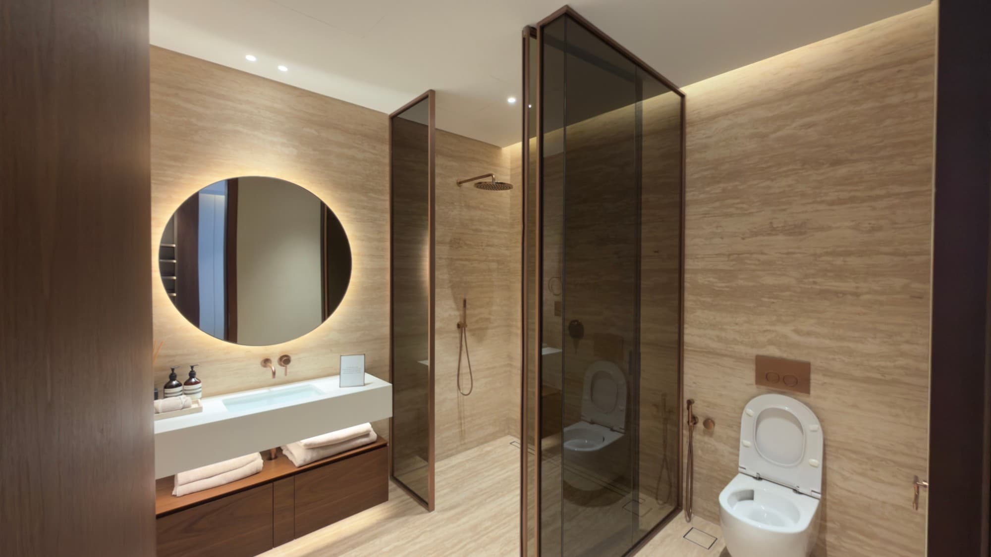 A further bathroom, with a backlit mirror and a walk-in shower